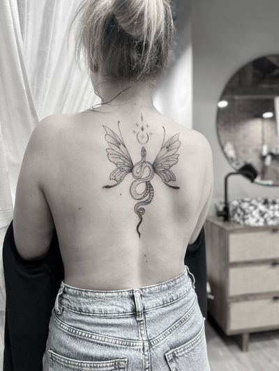 Embrace the enchanting world with this fine line tattoo by Aleks Fanta, featuring a snake, dragon, fairy, and wings.