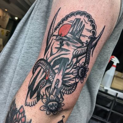 Get inked with a traditional style tattoo featuring a rugged western skull by the talented artist Benji Charnock.