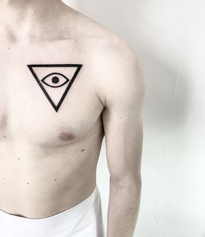 Explore the mesmerizing combination of intricate geometric patterns and a powerful eye symbol in this striking blackwork tattoo by Malvina Maria Wisniewska.